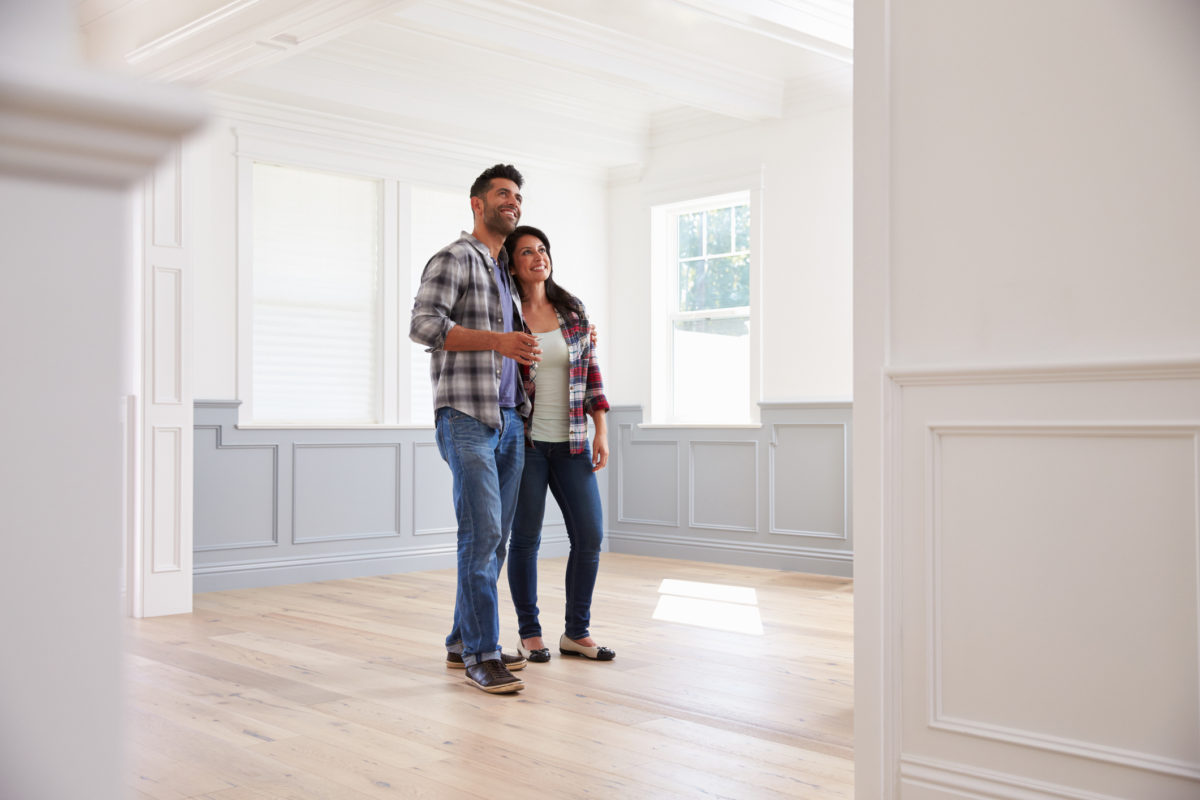 couple standing in an empty new home