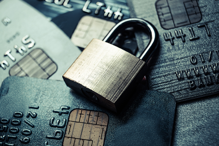 padlock sitting on top of credit cards