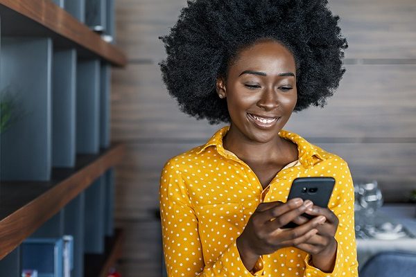 Business woman reading text message on mobile phone