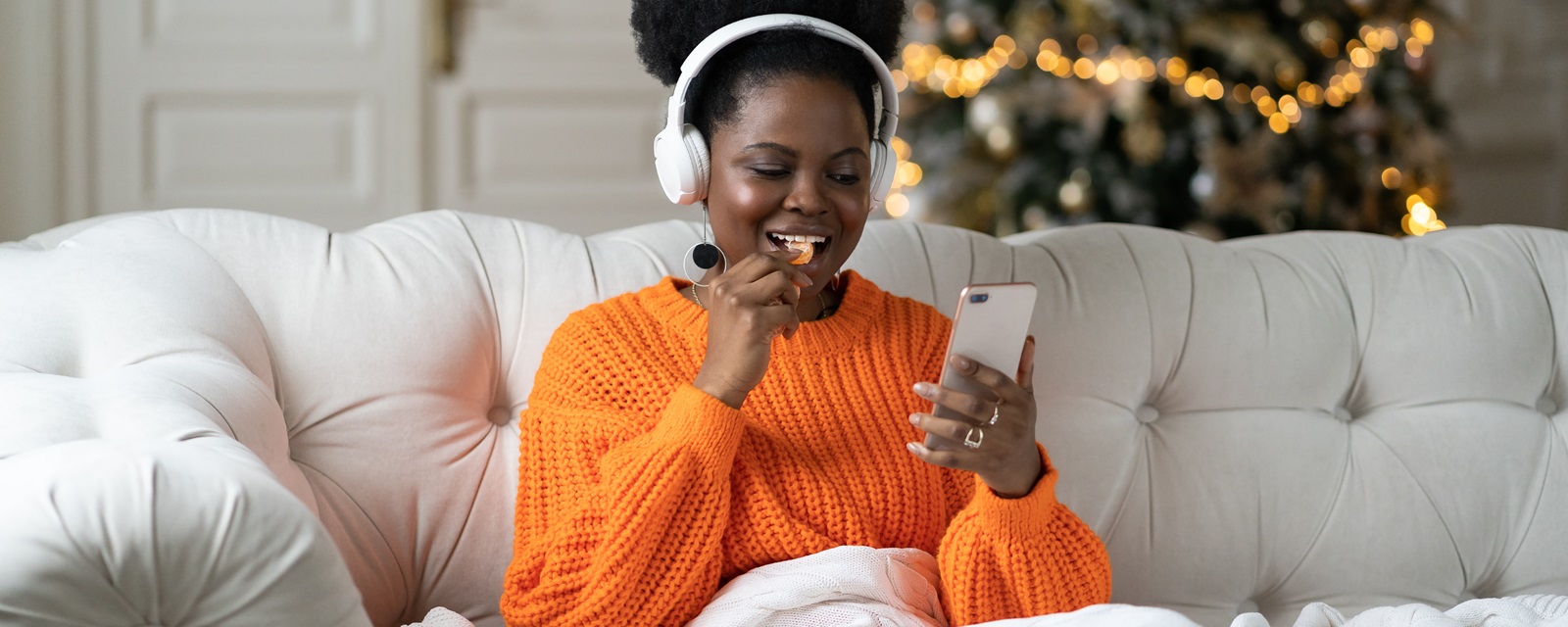 Woman sitting on couch using phone